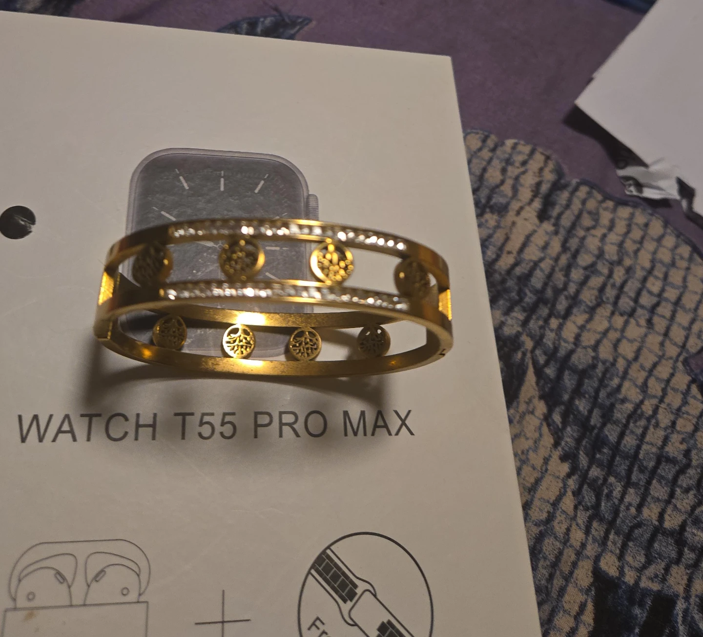 Gold-tone bracelet with rhinestones and intricate cutouts