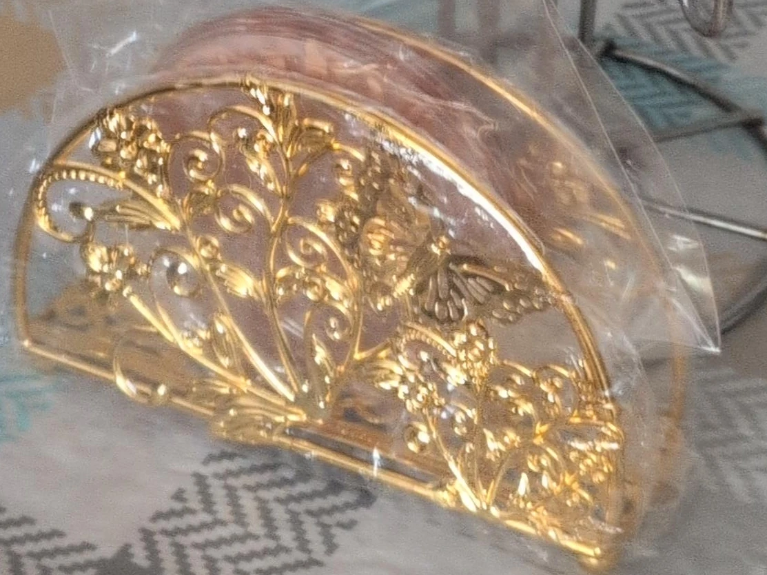 Gold metal napkin holder with floral and butterfly design