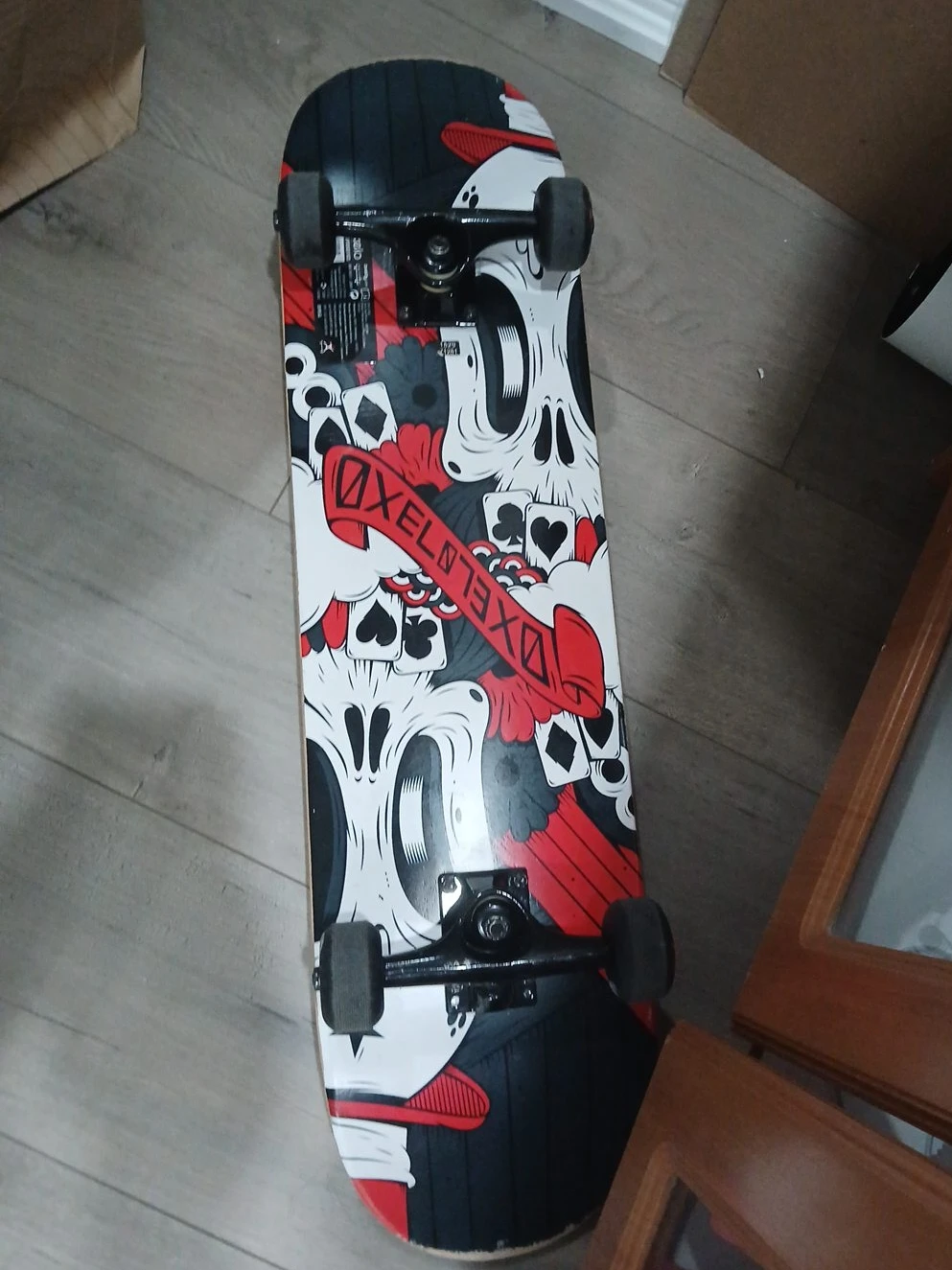 Skateboard with Skull and Playing Card Design