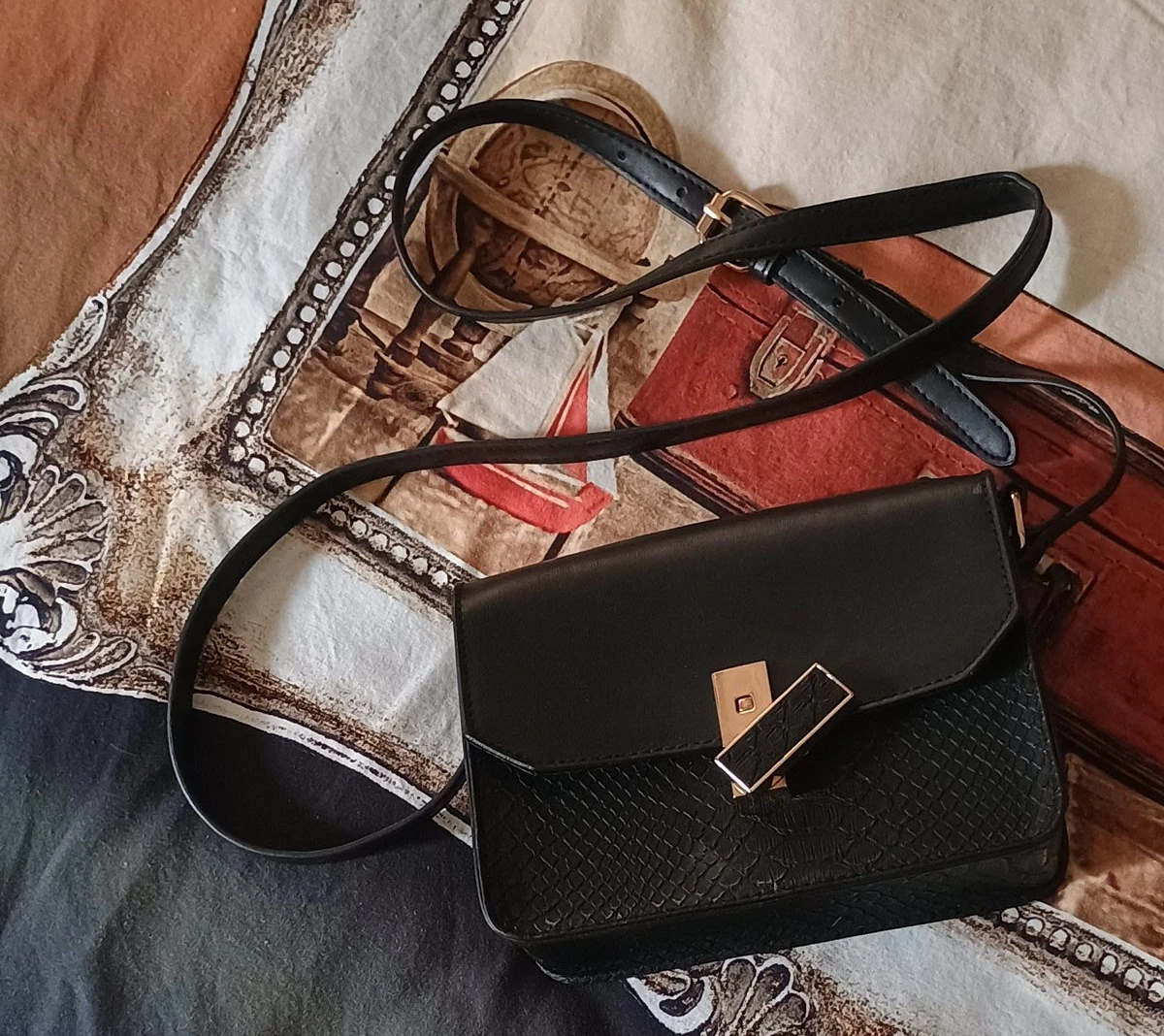 Black shoulder bag with gold clasp