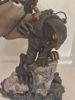 Fantasy creature statue with wings and red eyes