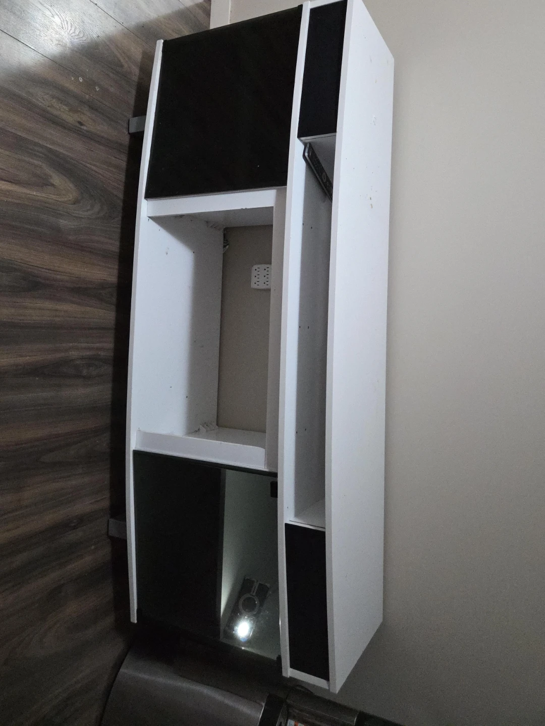 White and black shelving unit with black glass cover