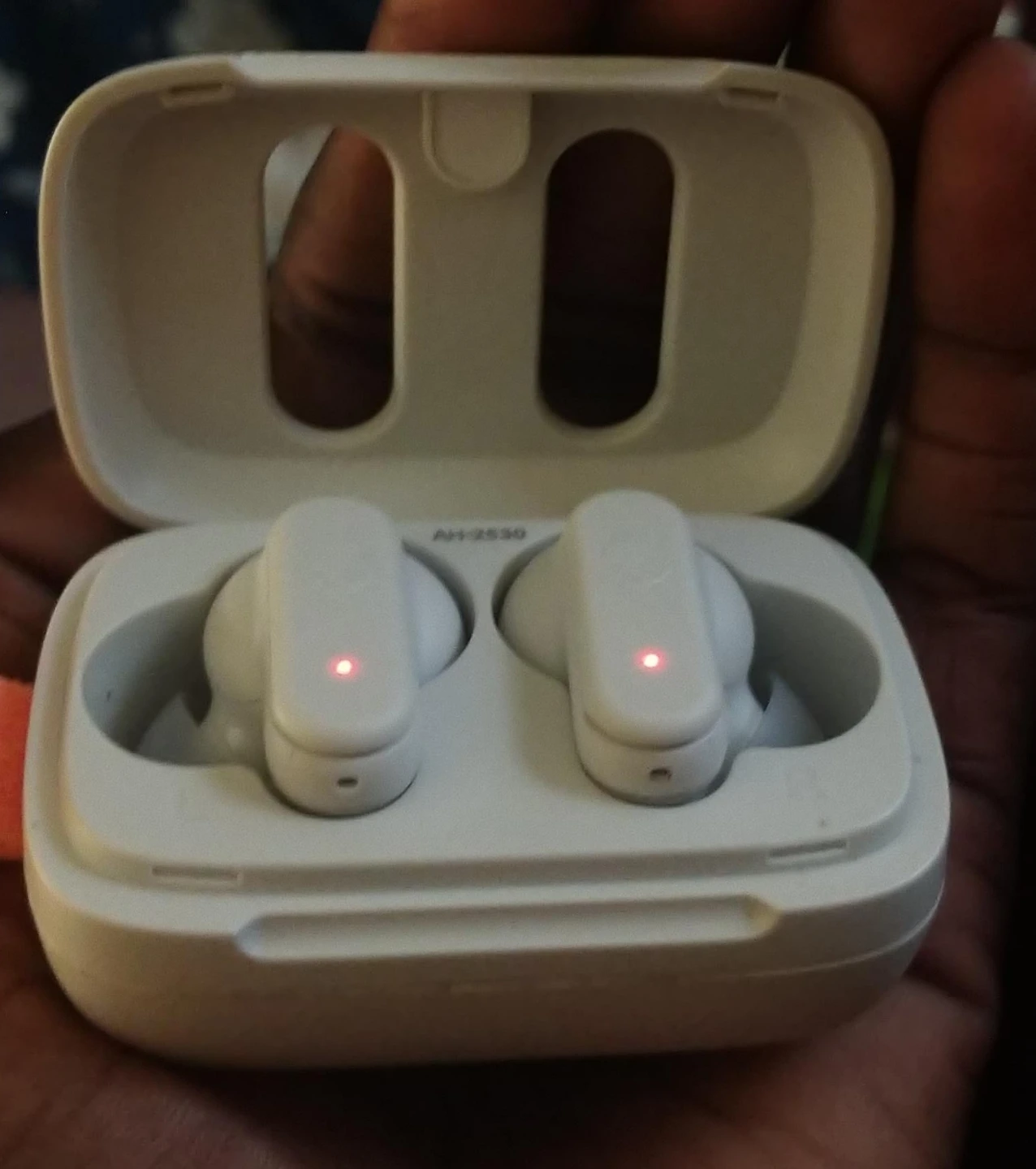White wireless earbuds with charging case
