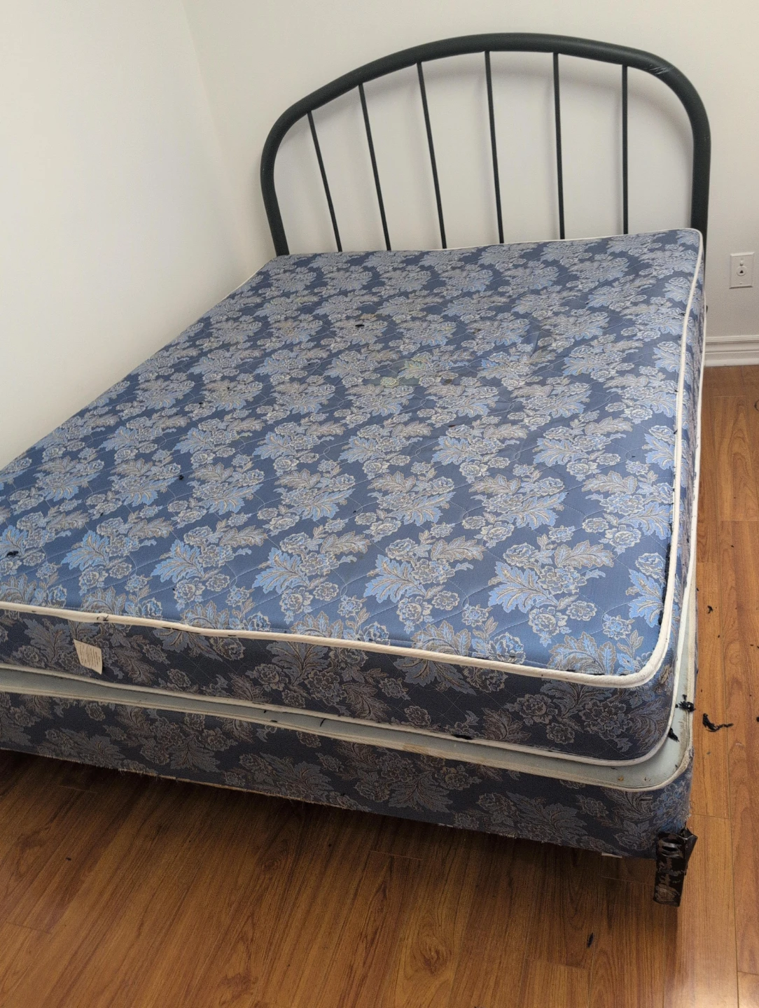 Blue floral mattress with black metal bed frame
