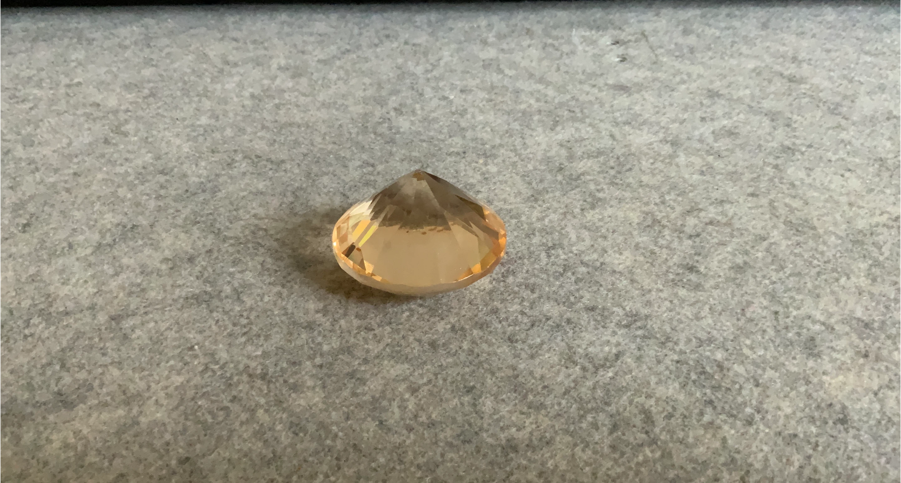 Peach-coloured faceted gem