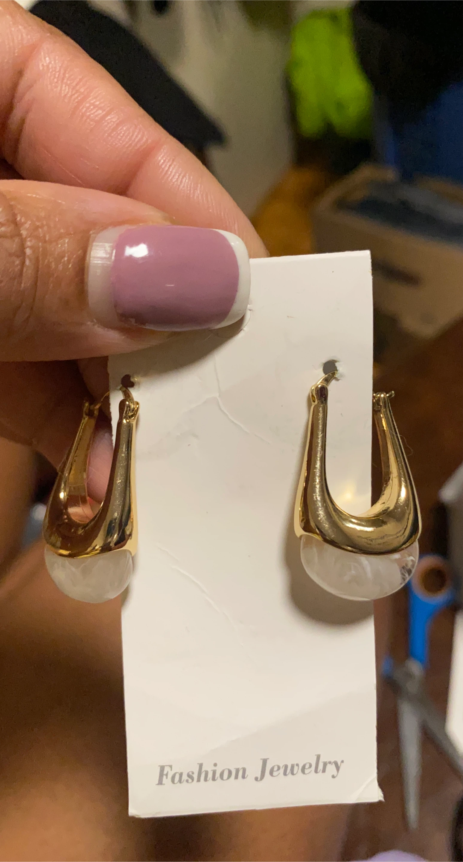 Gold-tone hoop earrings with white accents