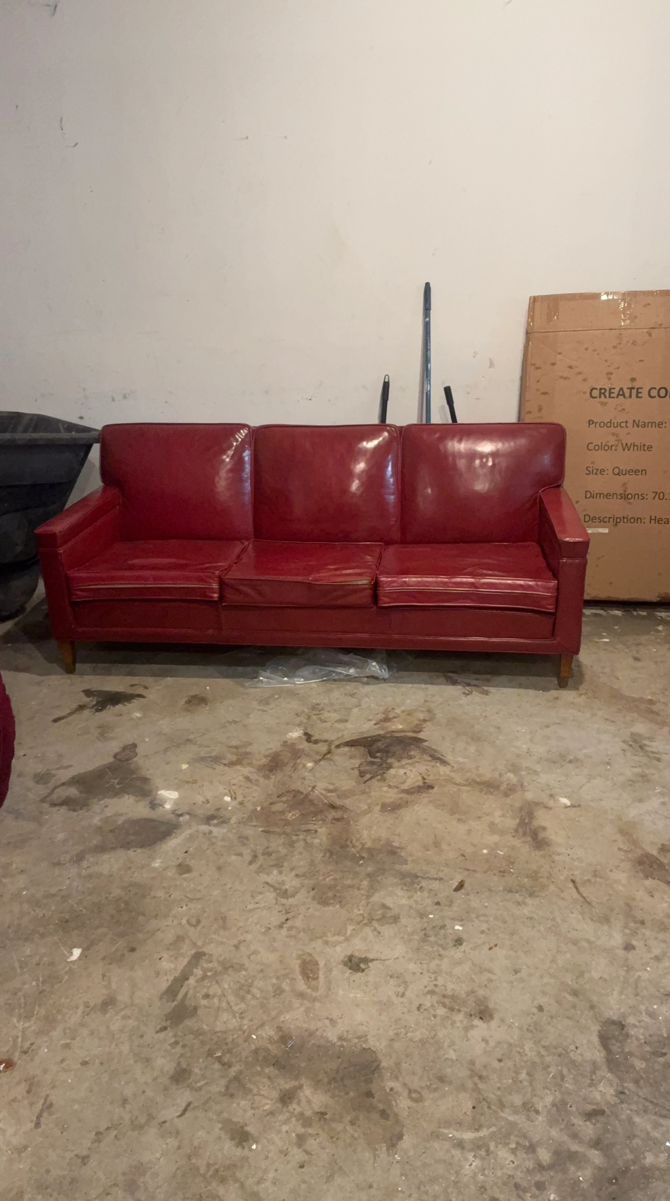 Red leather three-seater sofa