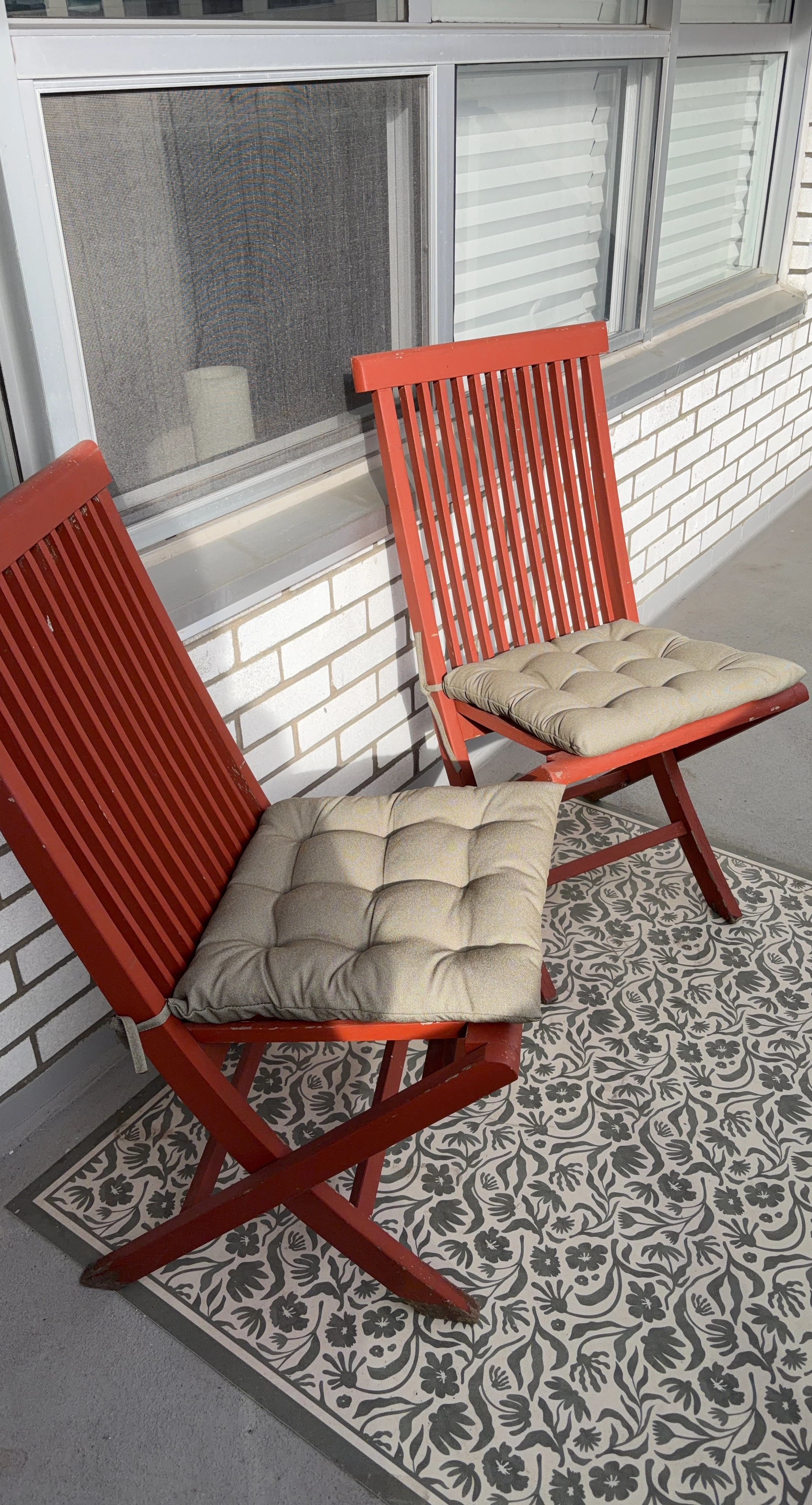 Two TEAK red outdoor folding chairs