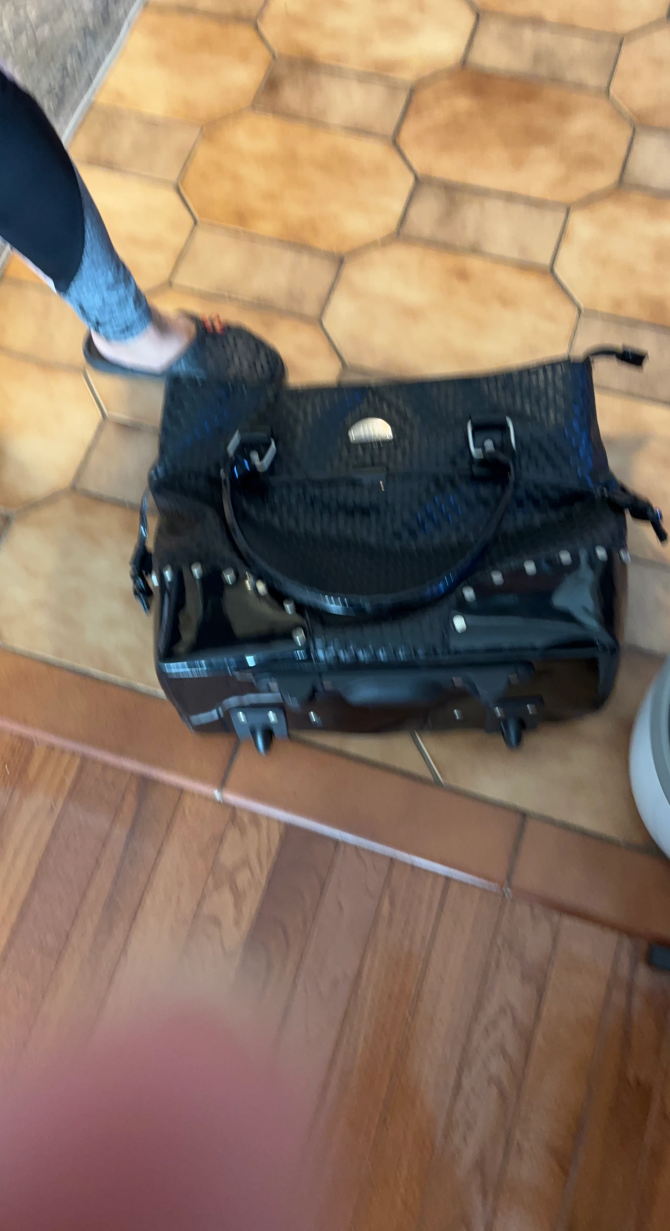 Black rolling travel duffel bag