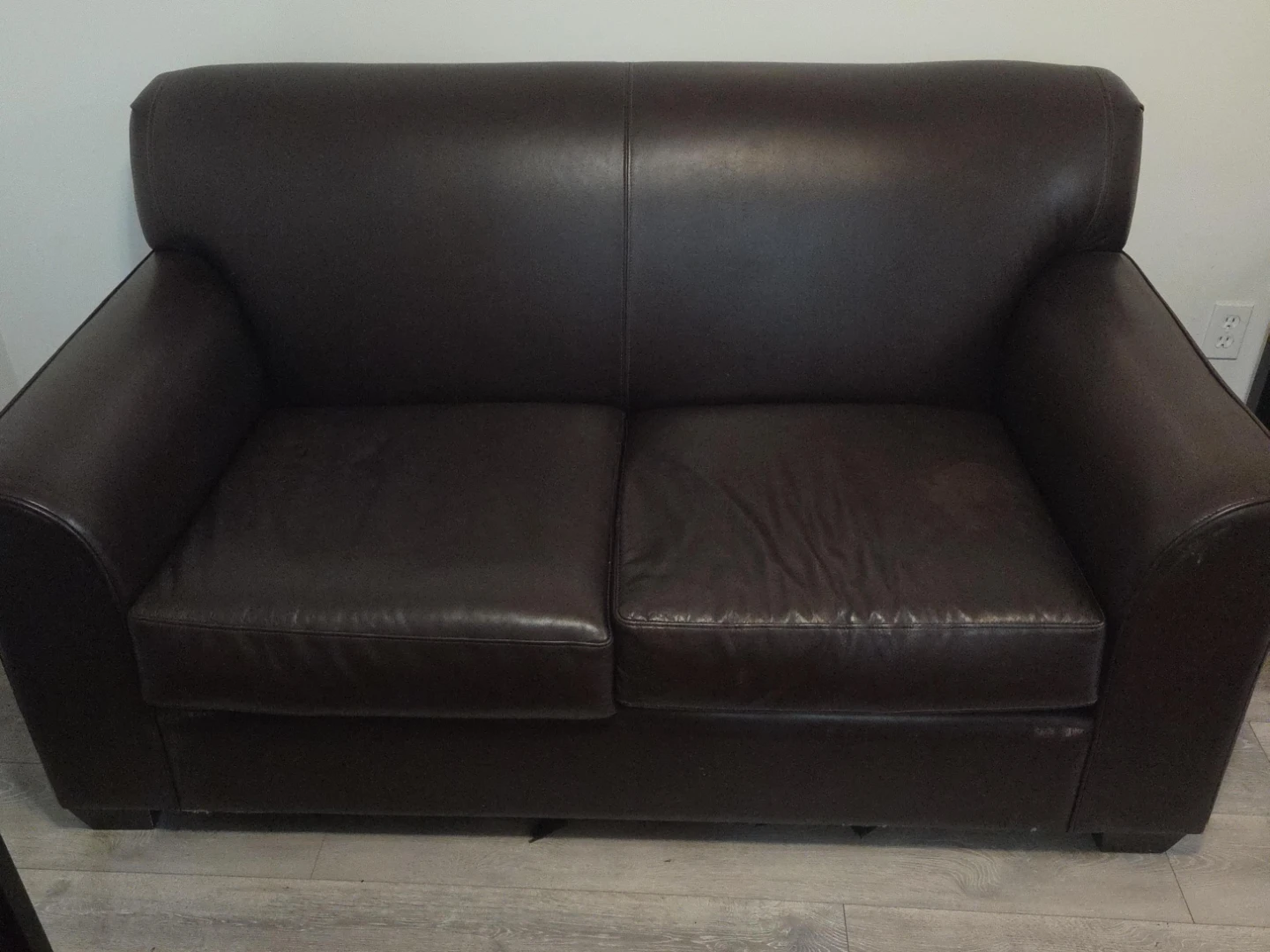Dark brown leather loveseat