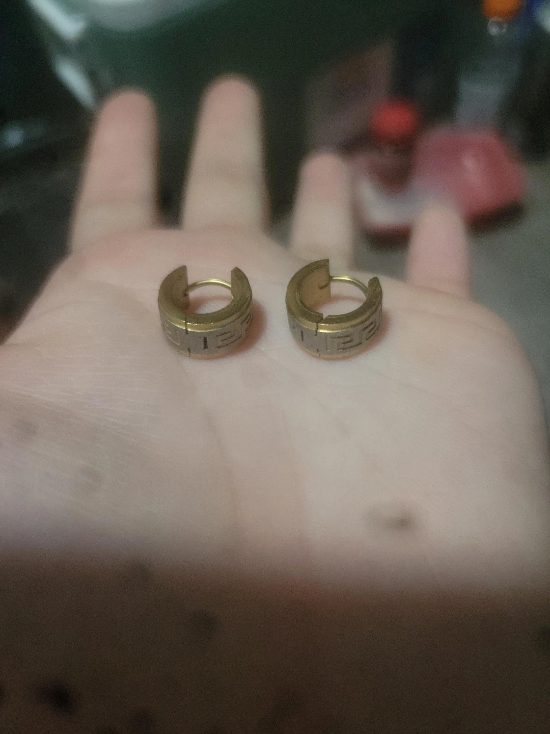 Gold tone hoop earrings with Greek key pattern