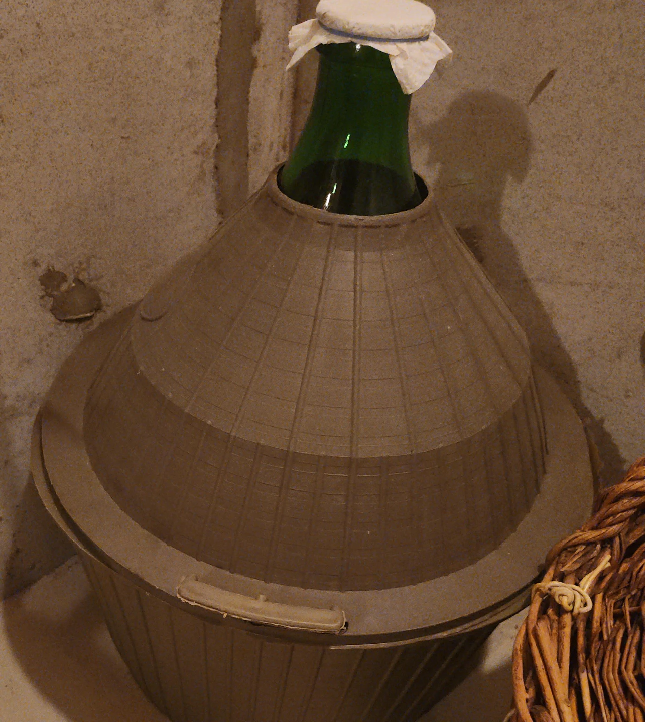 Large glass bottle with protective basket