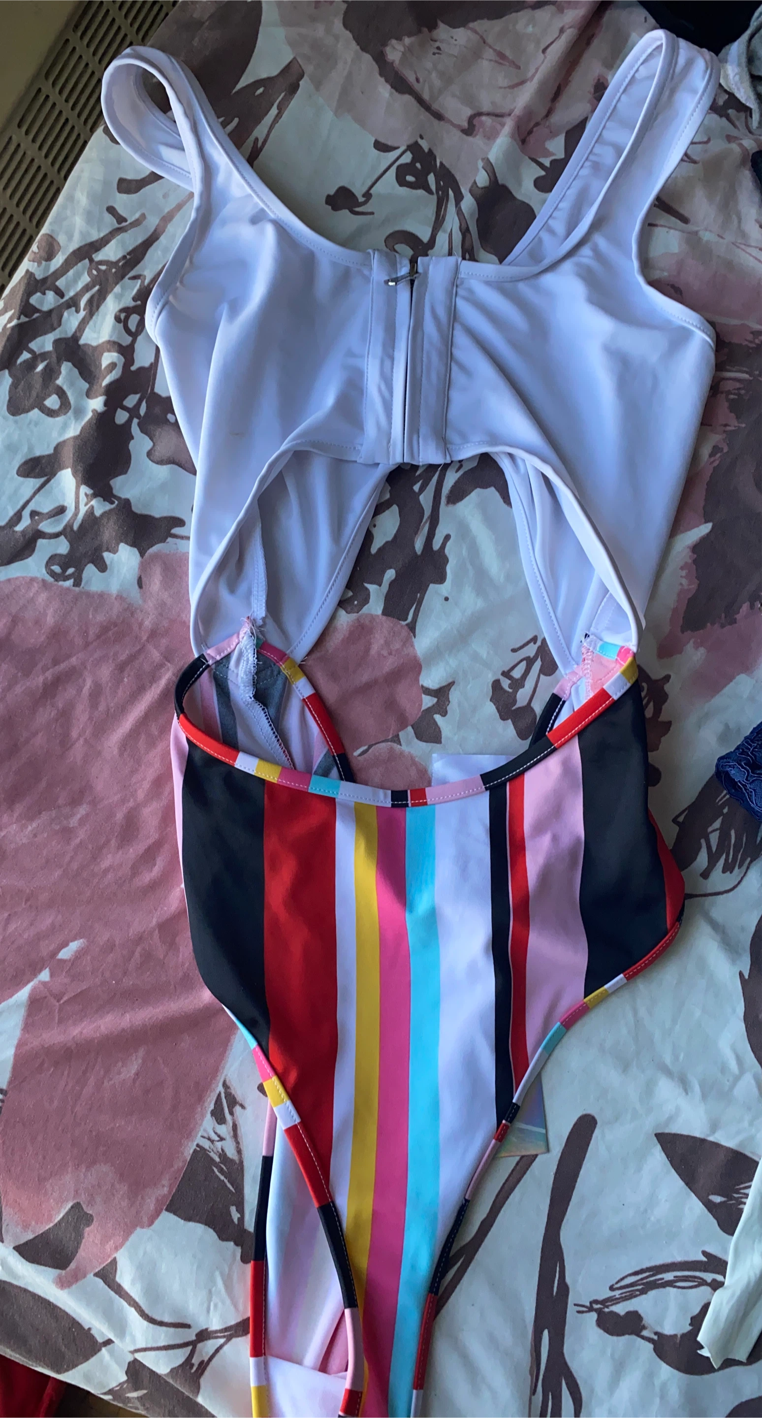 One-piece swimsuit with white top and striped bottom