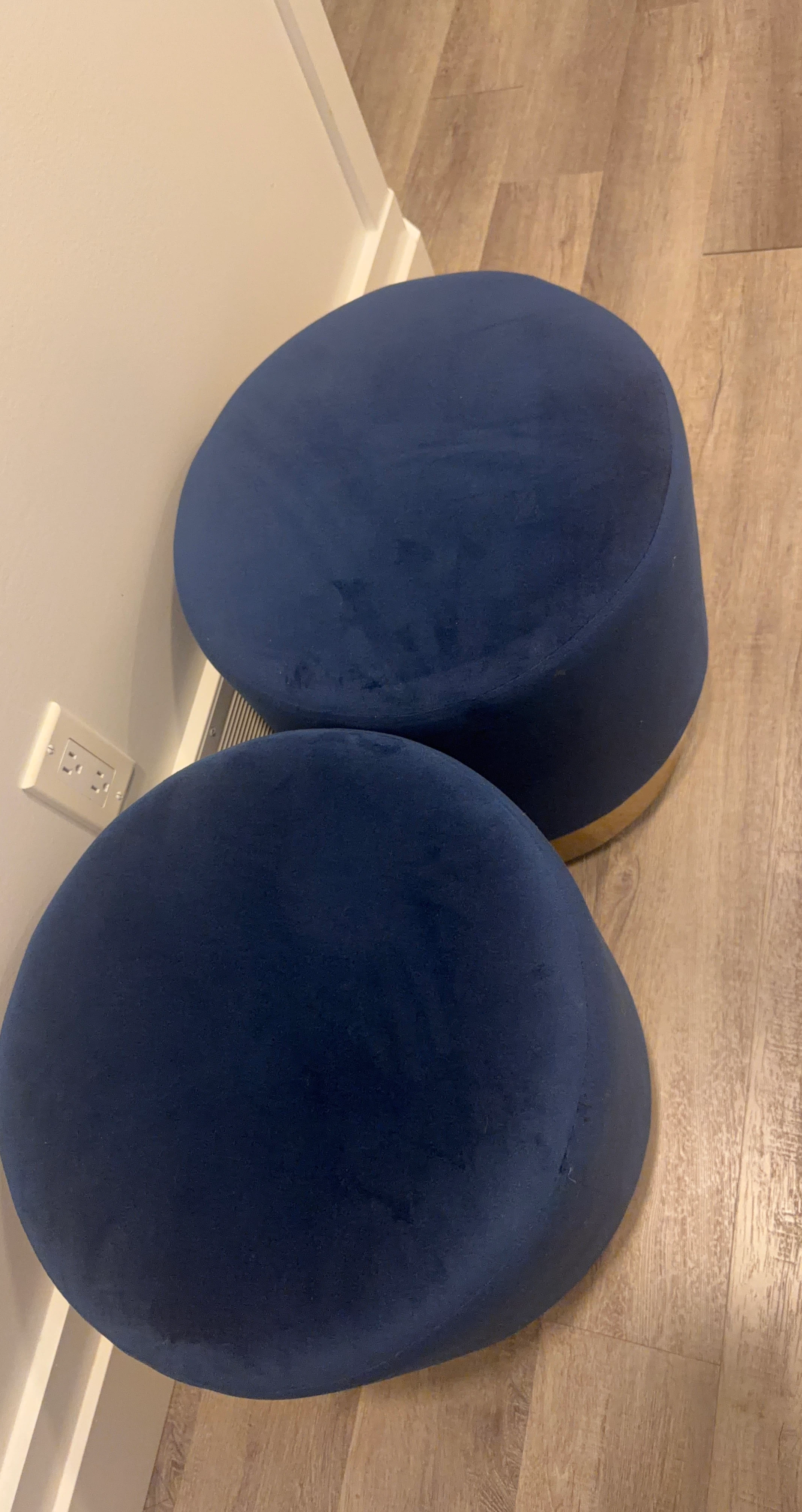 Two navy blue velvet ottomans