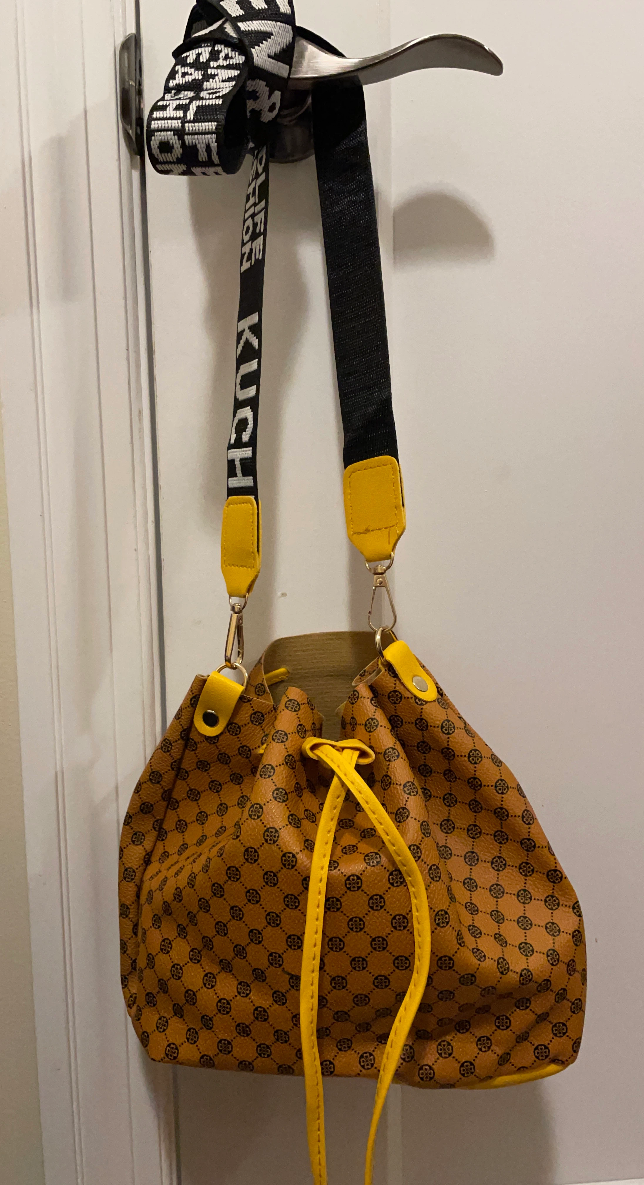 Brown patterned bucket bag with yellow accents