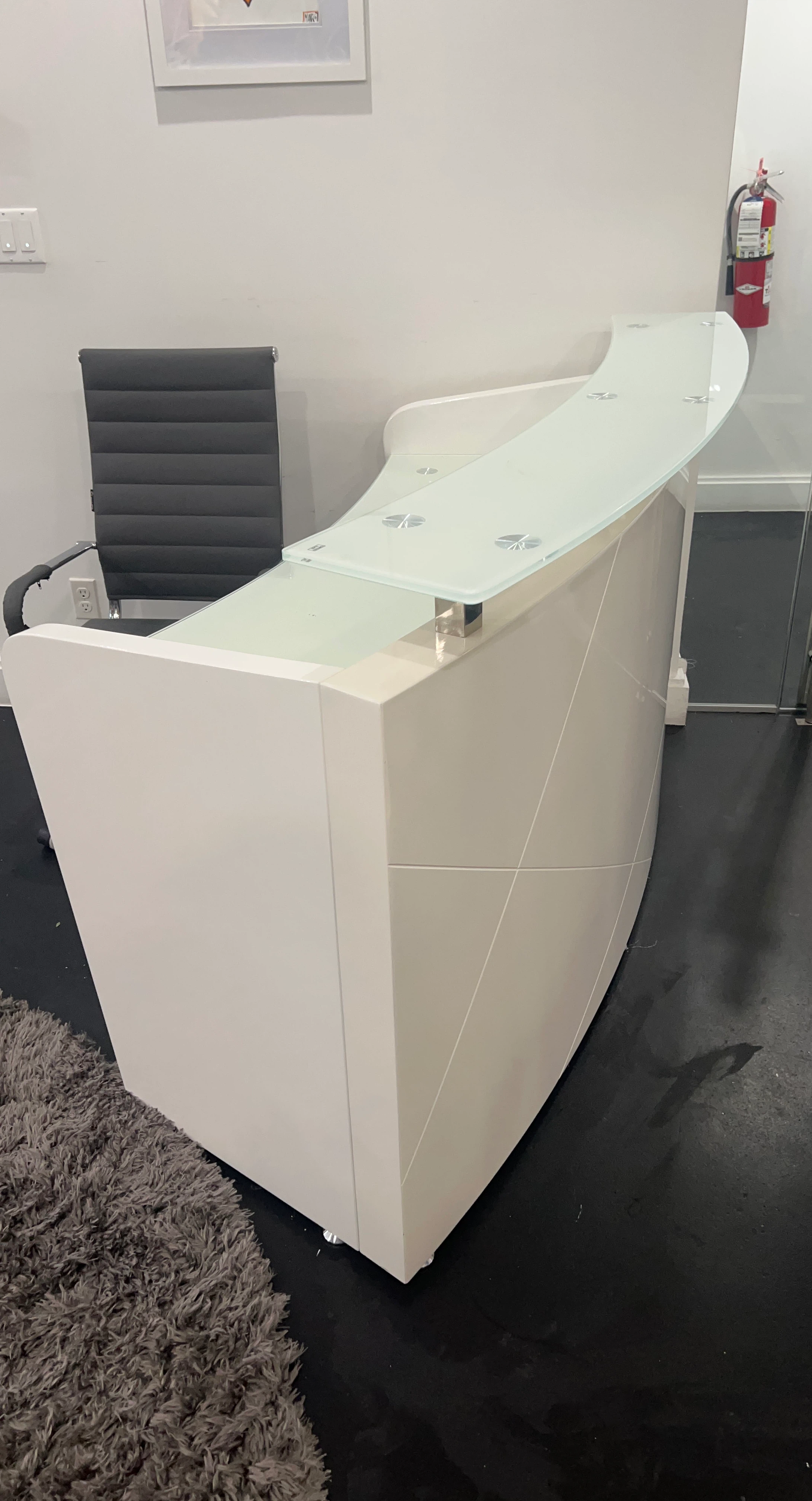 White reception desk with glass top