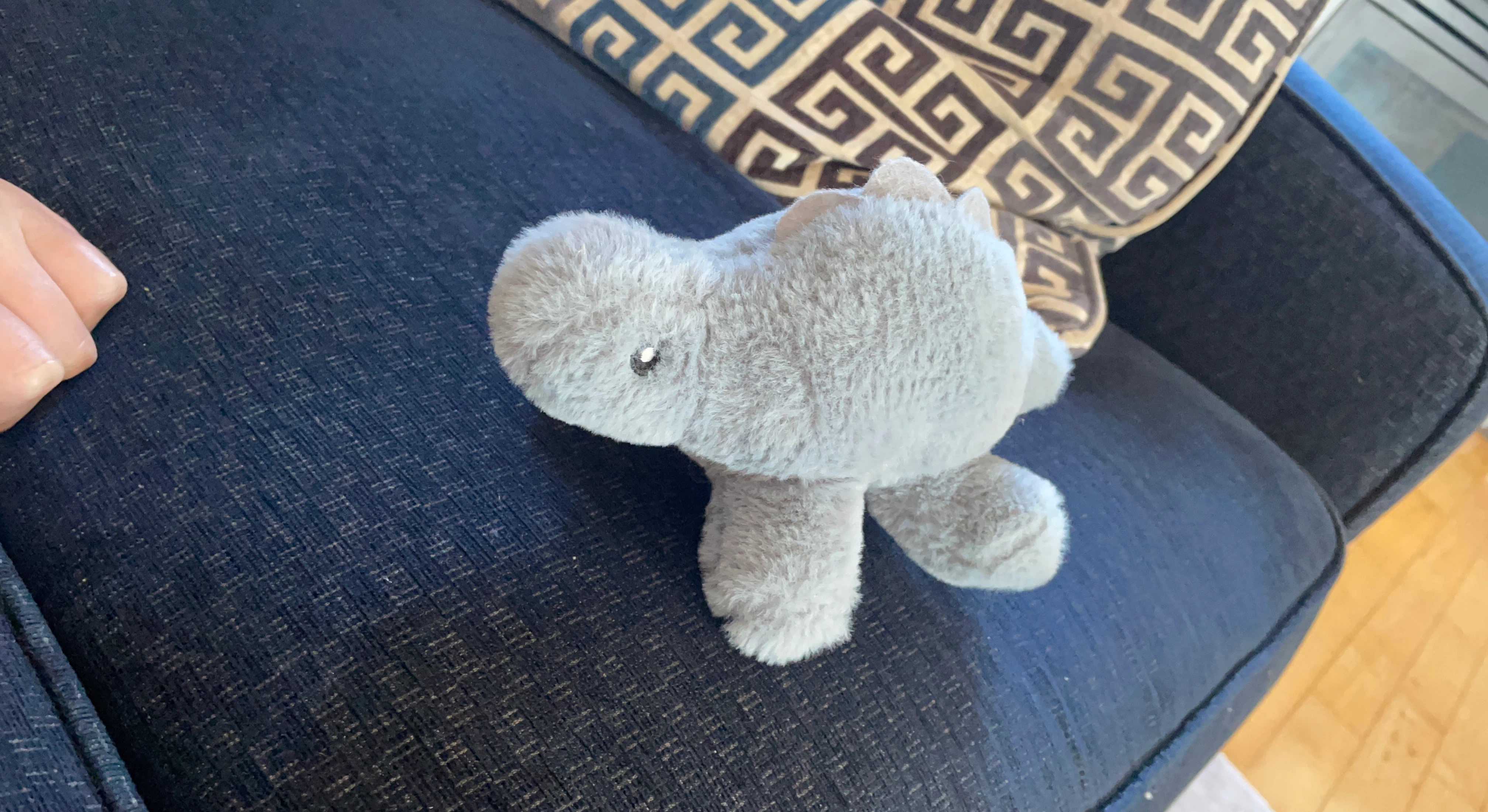 Grey plush dinosaur toy