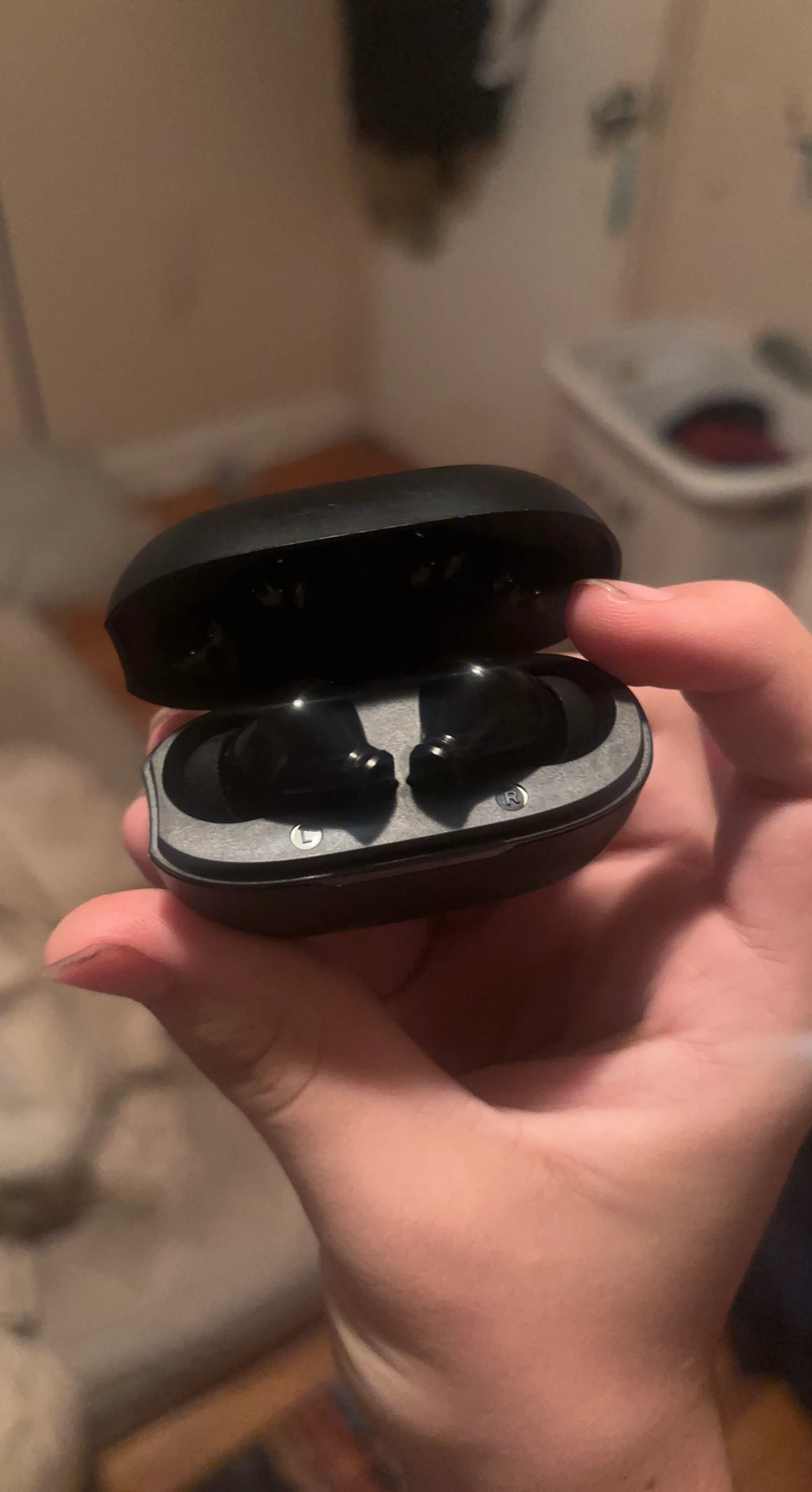 Black wireless earbuds with charging case