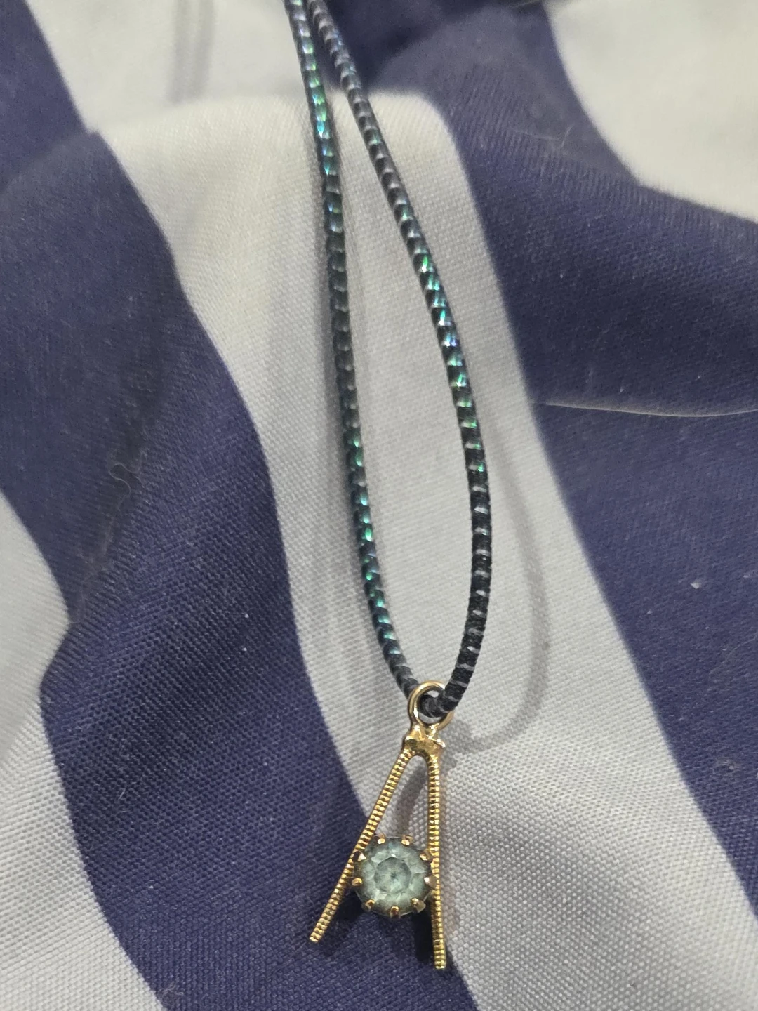 Gold-tone A-frame pendant necklace with blue gem