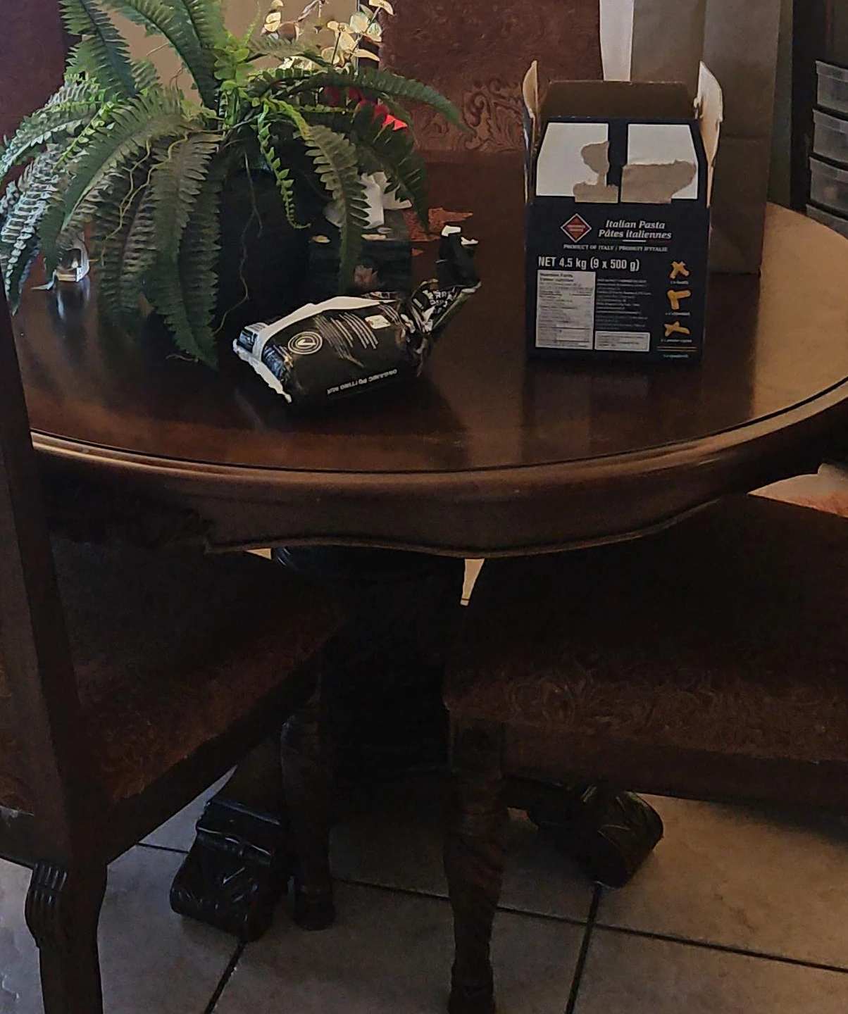 Large round dining room table with four chairs