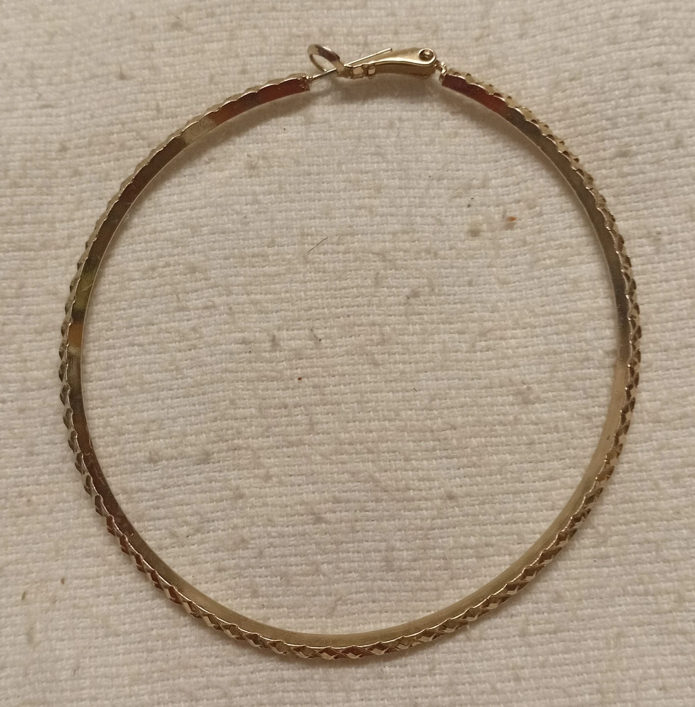 Gold-tone textured hoop earring